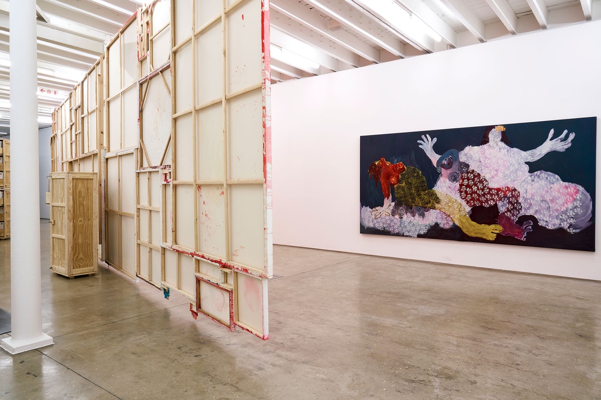 Installation photograph from the 'A Little After This' exhibition in A4 Arts Foundation's gallery. On the left, an installation of Penny Siopis' glue, ink and oil 'Maitland' paintings suspended from the ceiling. On the right, Portia Zvavahera's oil-based printing ink and oil bar on canvas work 'Embraced and Protected in You' mounted on a white gallery wall.
