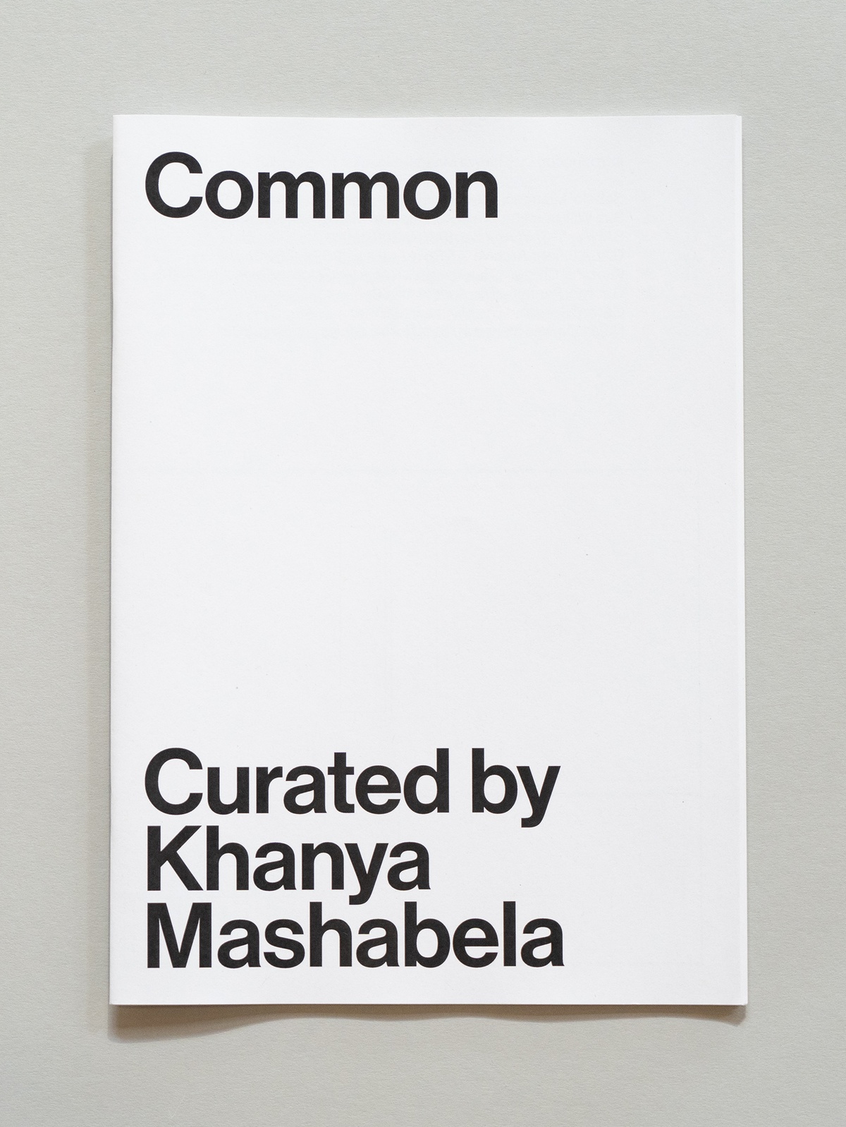 Photograph of the wayfinder publication for Common, curated by Khanya Mashabela in A4 Arts Foundation's Gallery.
