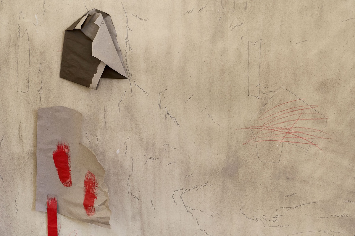 Process photograph from the 2nd rendition of ‘Parallel Play’ in A4’s Gallery. A detail of Asemahle Ntlonti’s wall mounted work shows a sheet of paper with pencil marks, and additional painted paper fragments pasted onto it.
