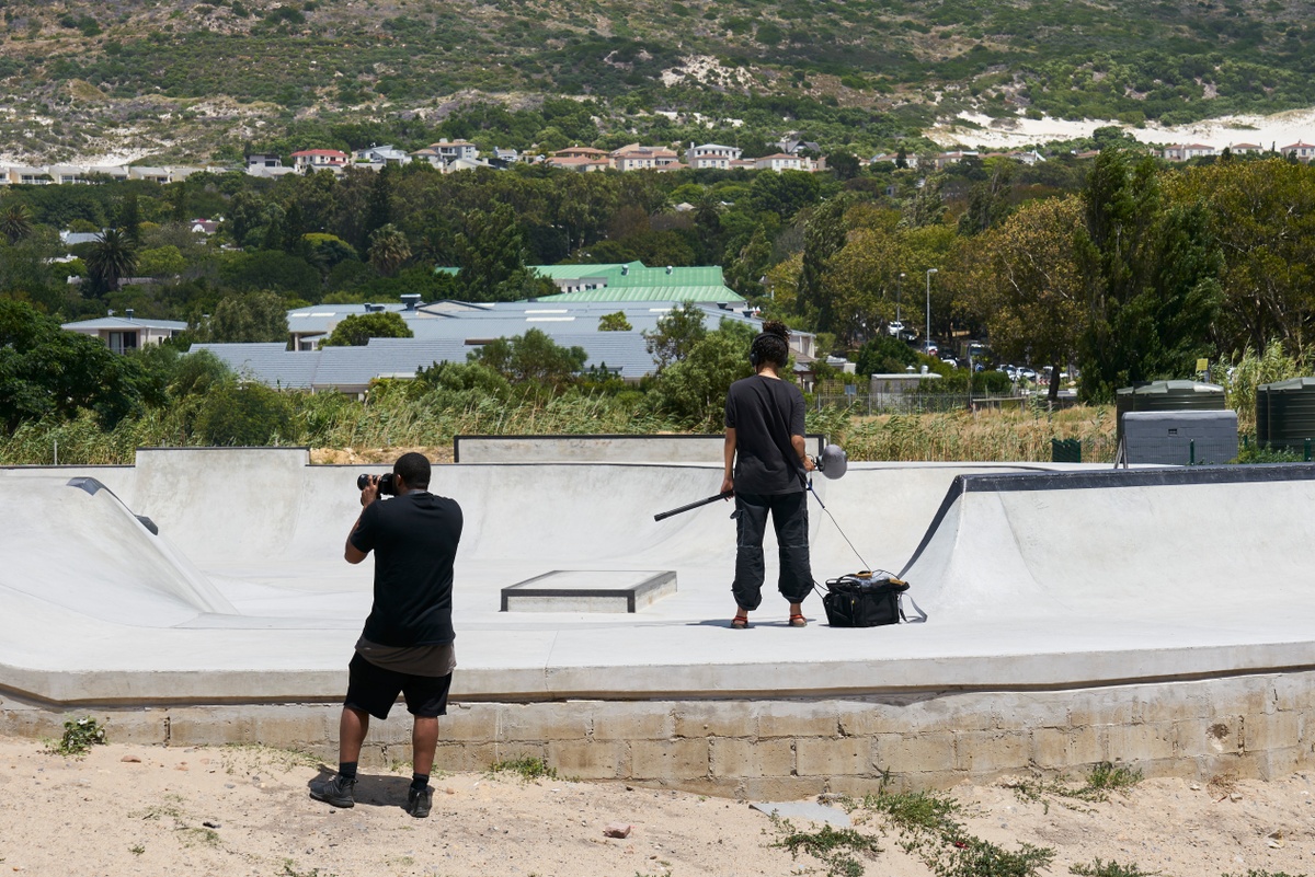 Process photograph from the ‘without a clear discernible image’ exhibition in A4’s Gallery that shows a photographer and an audio technician standing in a concrete skateboard park.
