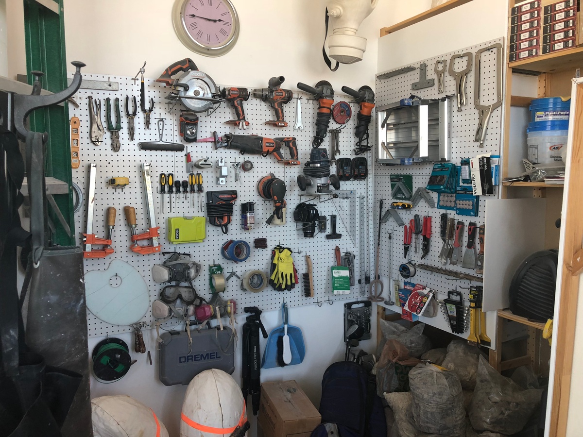 Process photograph from the 2018 offsite rendition of Curatorial Exchange with Art Institute Chicago that shows a white pegboard with a variety of tools.
