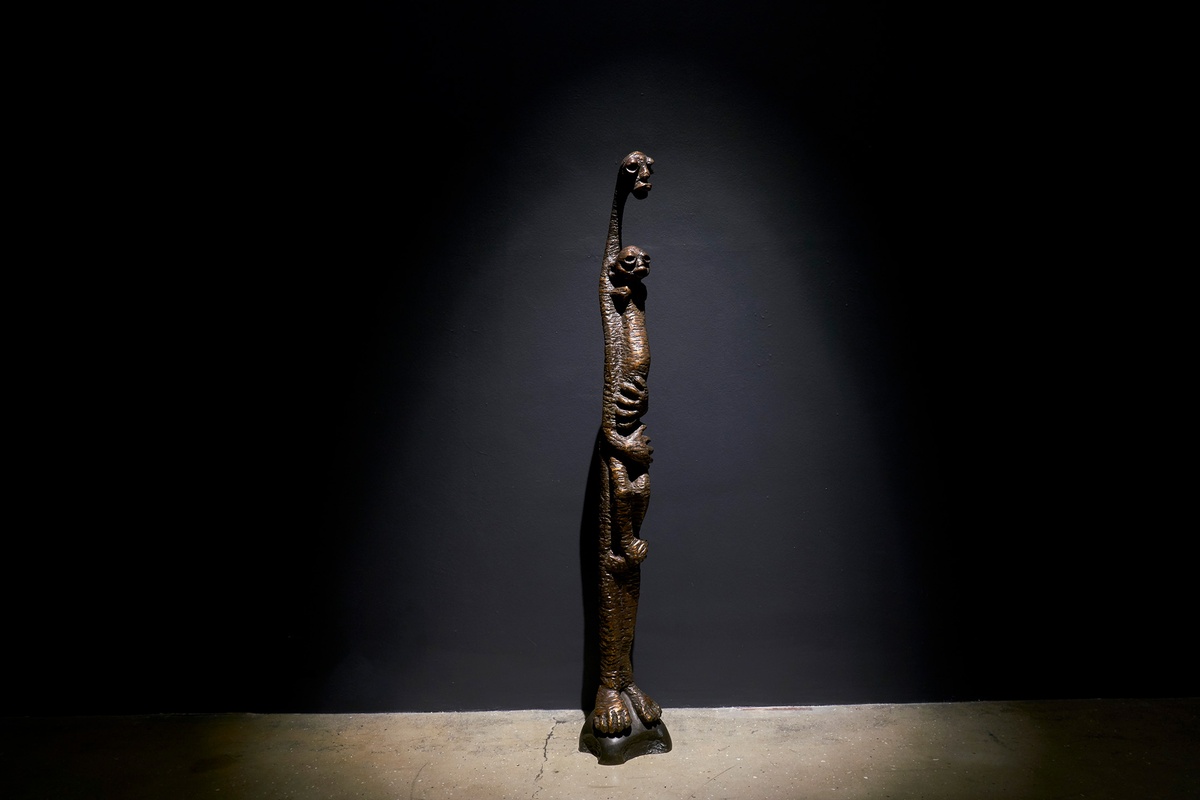 A photograph of Lucas Sithole’s bronze sculpture of a mother holding a child.

