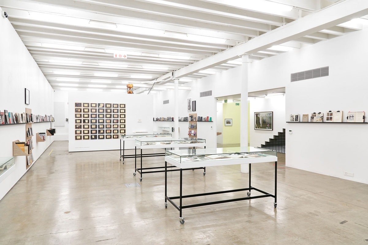 Installation photograph from the Photo Book! Photo-Book! Photobook! exhibition in A4’s Gallery. On the left, Sue Williamson’s photographic series ‘For Thirty Years Next to His Heart’ hangs on a moveable wall in an area dedicated to photobooks from the years 1967 to 1994.
