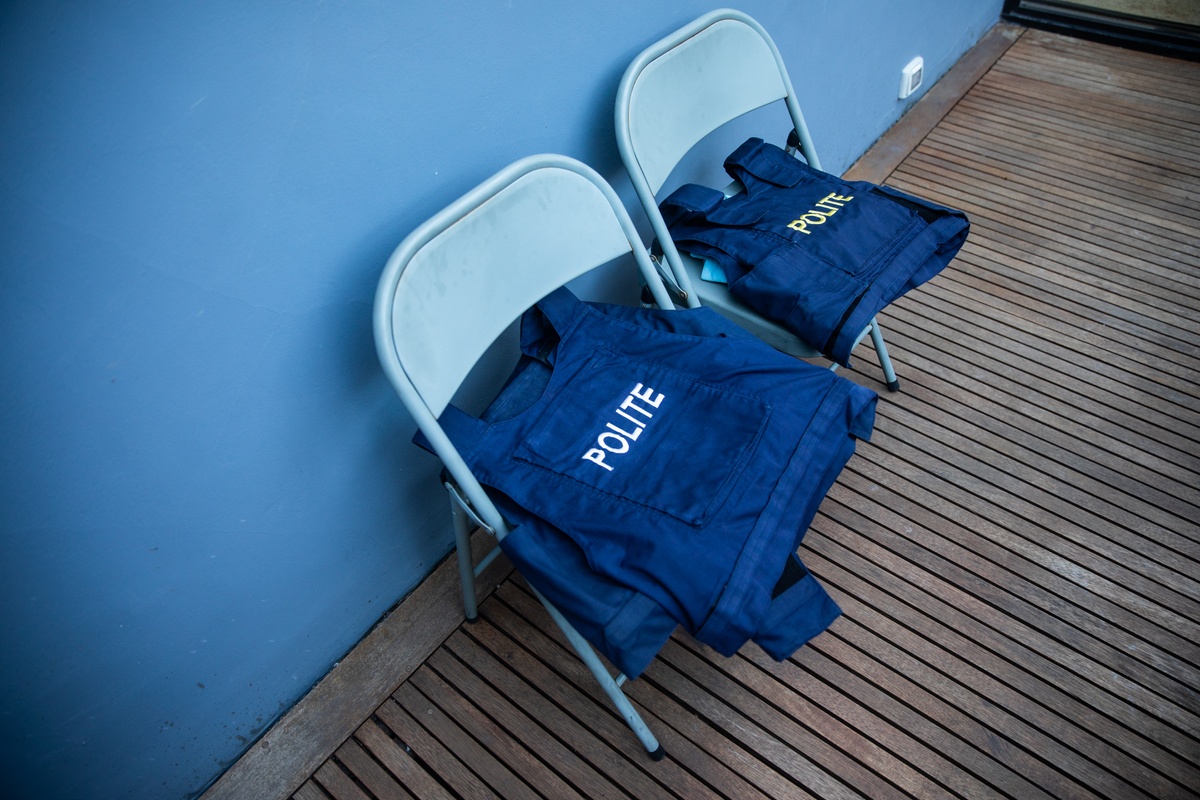 Process photograph from the 2019 rendition of Christian Nerf’s performance piece ‘Polite Force’ that shows two chairs with ‘Polite Force’ vests on A4’s 2nd floor patio.
