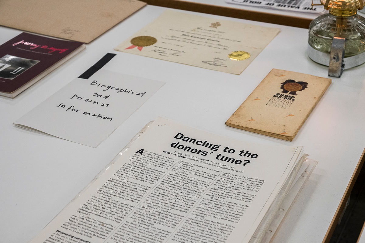 Installation photograph from the ‘Gladiolus’ exhibition on A4’s ground floor that shows printed matter arranged on a table. On the left, a stapled copy of Gladys Thomas’ ‘A walk along the promenade’. On the right, a photocopy of Thomas’ short story ‘Little boy lost in a township jungle’.
