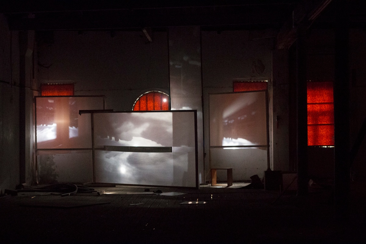 Installation photograph from George Mahashe’s ‘Camera Obscura #3’ exhibition on A4’s top floor. The darkened space features freestanding surfaces with a projected images from A4’s exterior facilitated by Mahashe’s pinhole camera.
