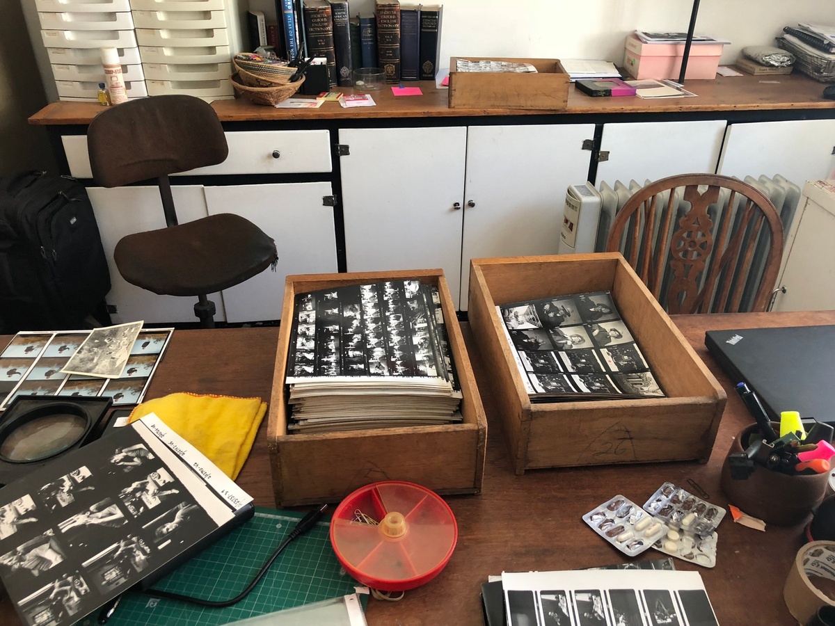 Process photograph from the ‘Picture Theory’ exhibition in A4’s Gallery. In the middle, two wooden boxes hold stacks of photographic contact sheets.
