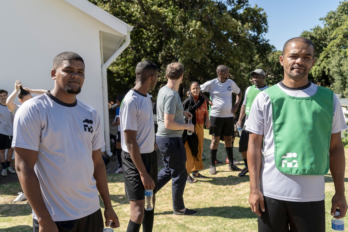 Match day photograph from the 2022 rendition of Exhibition Match that shows players attending a soccer match.
