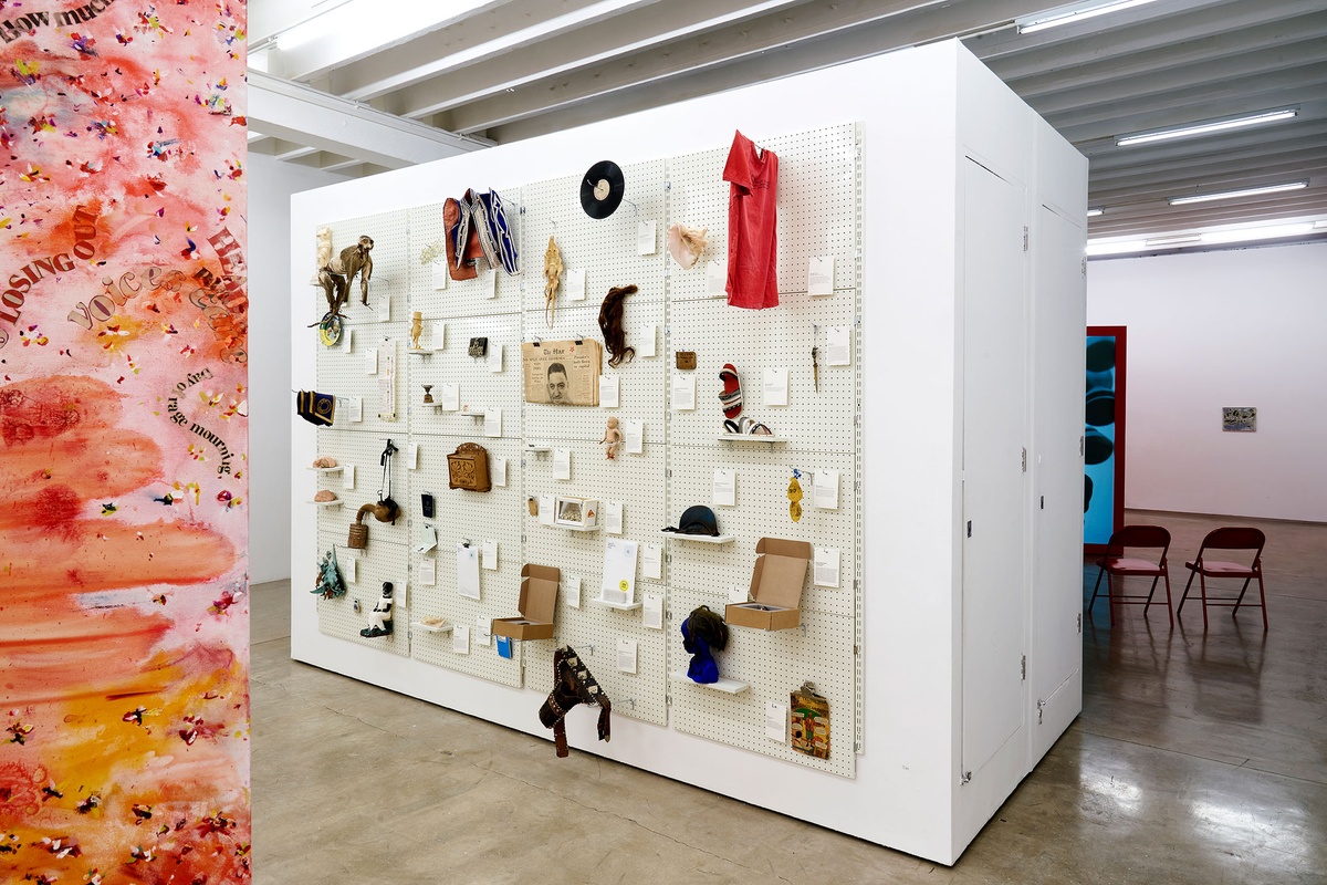 Installation photograph from the 'A Little After This' exhibition in A4 Arts Foundation's gallery. On the left, an installation of Penny Siopis' glue, ink and oil 'Maitland' paintings suspended from the ceiling. In the middle, collected objects from Penny Siopis' 'Will' work mounted on a white moveable gallery wall through the use of perforated metal panels. On the right, Gerard Sekoto's oil on canvas painting 'Le Pont St. Michel' mounted on a white gallery wall.
