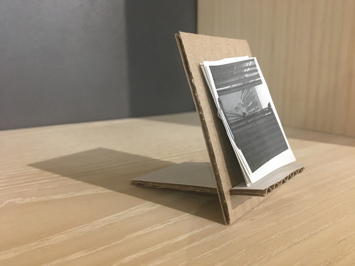 Process photograph from the offsite ‘Corner of the Eye / Le Coin de L’oeil’ exhibition at the Kadist Art Foundation, Paris shows a printed booklet on a cardboard bookstand.
