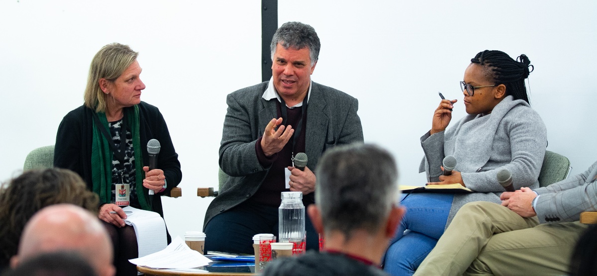 Event photograph from the 2018 rendition of the Open Book festival on A4’s ground floor. At the back, three panelists are seated with microphones. On the left, Pippa Green.
