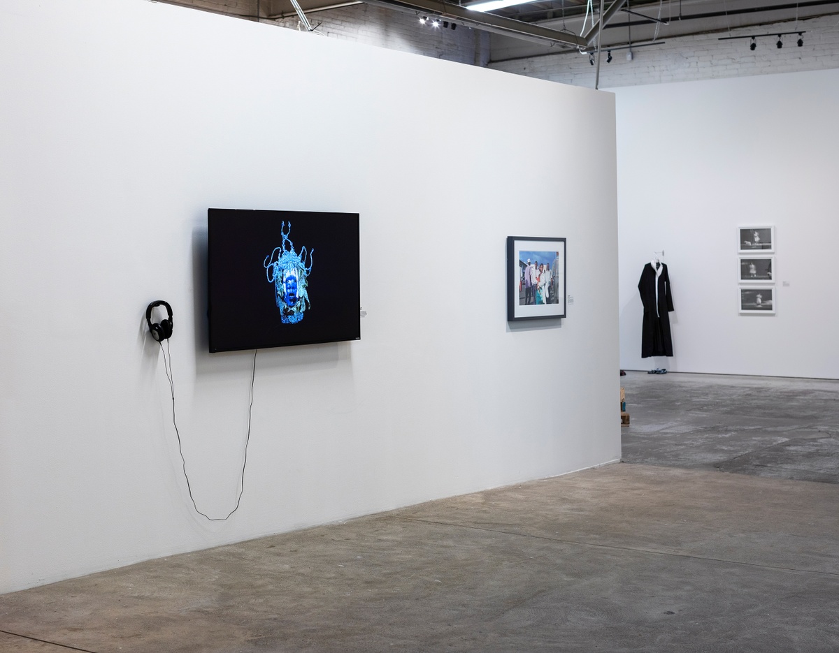 Installation photograph from ‘Crossing Night: Regional Identities x Global Context’ exhibition at the Museum of Contemporary Art Detroit. On the left, Athi-Patra Ruga’s video ‘Over the Rainbow’ is displayed on a wall-mounted screen.
