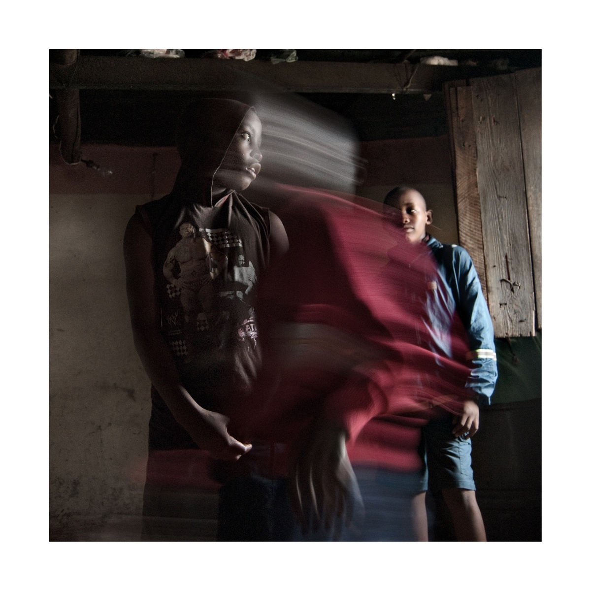 Photograph from Jabulani Dhlamini’s residency on A4’s top floor depicts three children moving indoors.
