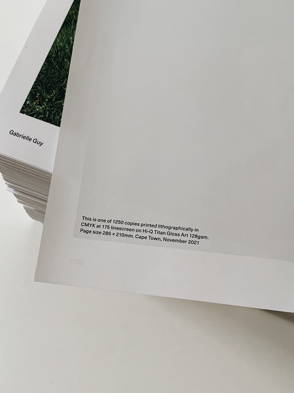 Photograph of the printed description on the back of Gabrielle Guy’s lithographic print ‘END x 1250’, that reads: “This is one of 1250 copies printed lithographically in CMYK at 175 linescreen on Hi-Q Titan Gloss Art 128gsm. Page size 285 x 210mm. Cape Town, November 2021.”
