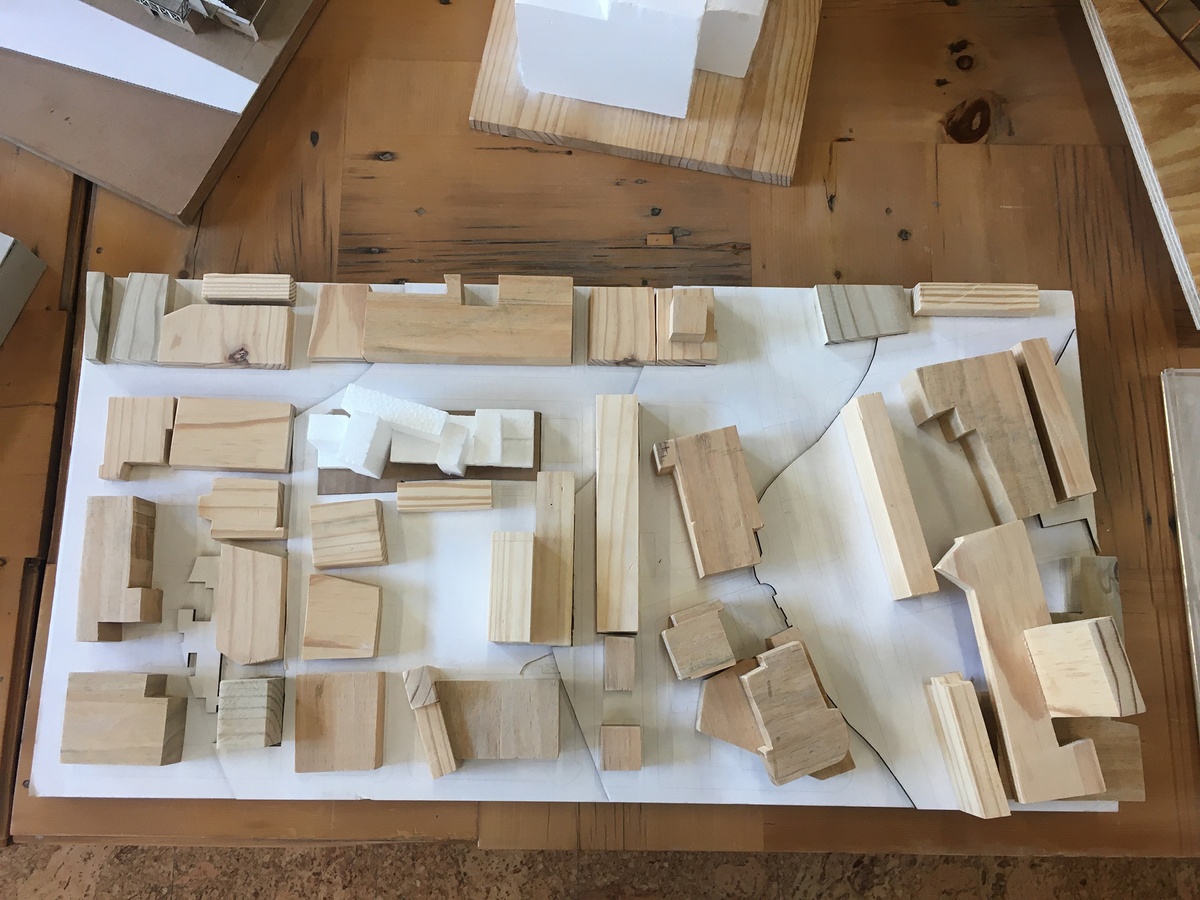 Photograph of an artwork from the Masters of Architecture Graduate Exhibition on A4’s top floor that consists of a cardboard model of a building.
