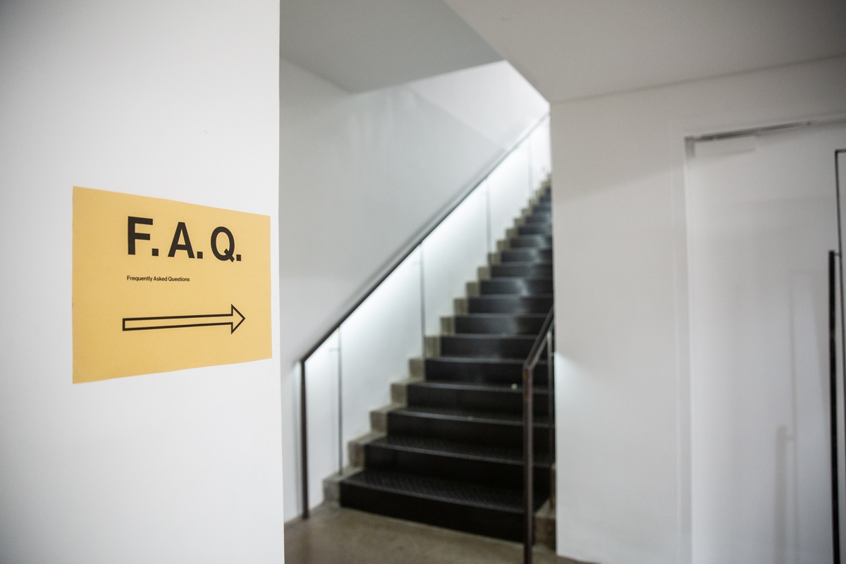 Event photograph from the ‘F.A.Q.’ (Frequently Asked Questions) event organised in collaboration with Museum Night South Africa in A4’s Gallery. On the left, a small poster in A4’s ground floor indicates that the event is happening upstairs in A4’s Gallery.
