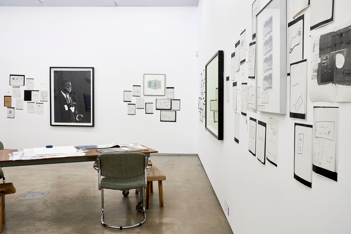 Installation photograph from the 2018 rendition of ‘Parallel Play’ in A4’s Gallery. At the back, Sam Nhlengethwa’s charcoal drawing ‘Portrait of Miles Davis’ is mounted on the gallery wall, along with photocopies from a notebook. On the right, Moshekwa Langa’s gouache and pencil work ‘I Am So Sorry (Green)’ is mounted on the gallery wall, along with photocopies from a notebook.
