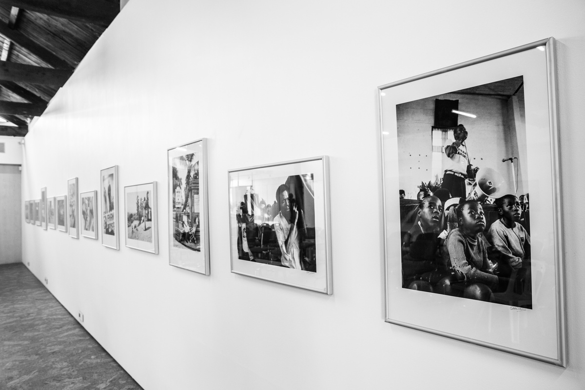 Installation photograph from the launch of Omar Badsha’s book ‘Seedtimes’ on A4’s top floor that shows a row of Omar Badsha’s monochrome photographs mounted on a wall.
