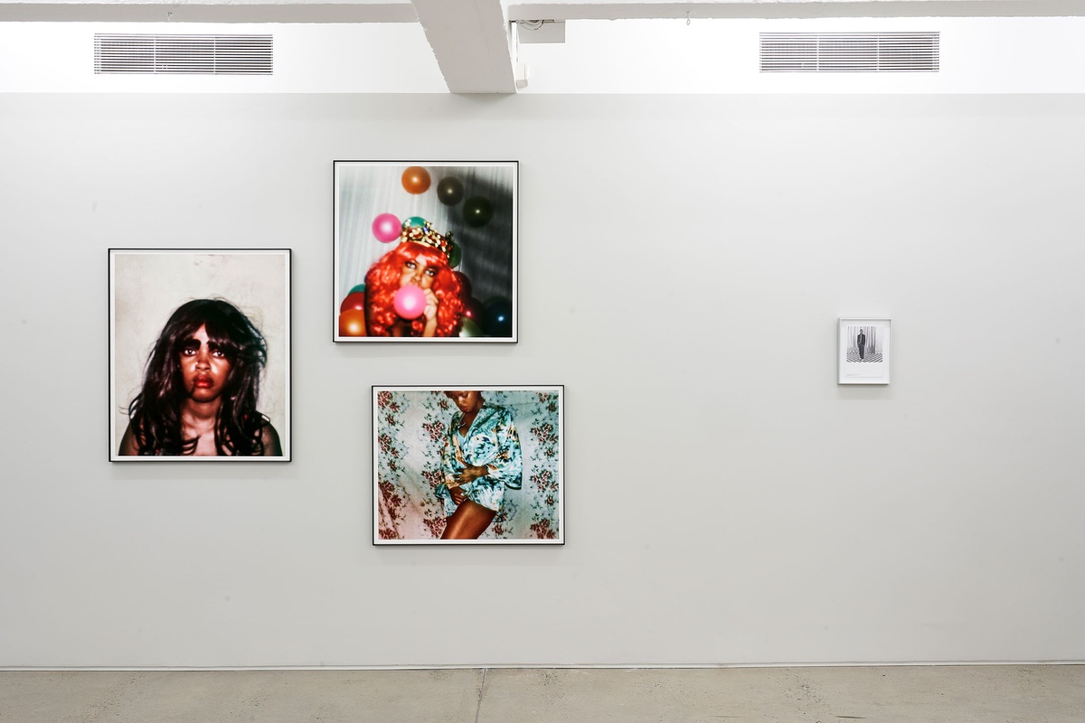 Installation photograph from the ‘Model’ exhibition in A4’s Reading Room. On the left, three framed photographs from Phumzile Khanyile’s ‘Plastic Crowns’ series. On the right, Samuel Fosso’s framed photograph ‘Autoportraits II (Fosso Fashion)’.
