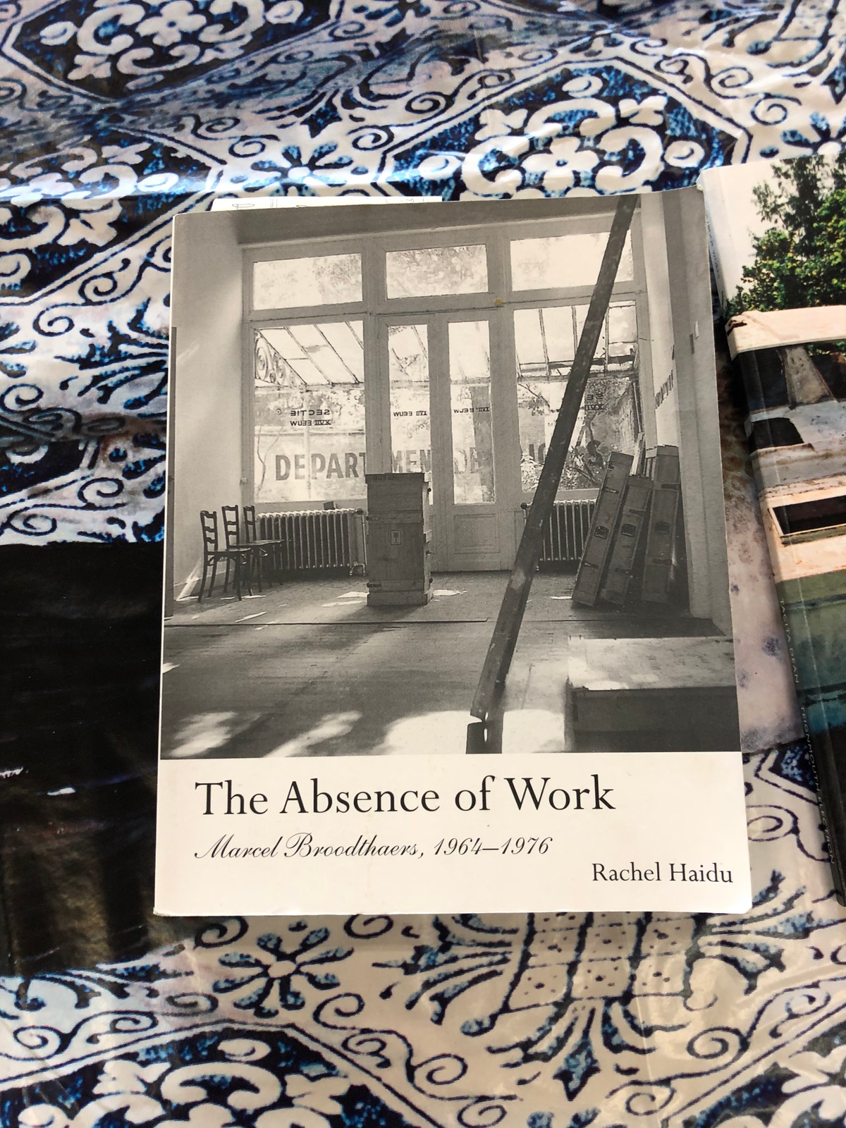 Process photograph from the More For Less exhibition in A4’s Gallery that shows a copy of Rachel Haidu’s book ‘The Absence of Work: Marcel Broodthaers, 1964-1976’.
