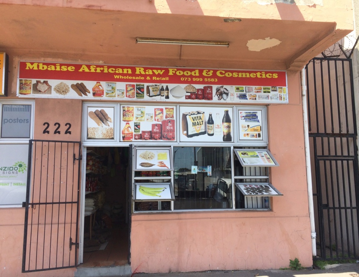Process photograph from the 2018 rendition of the City Research Studio exchange with the African Centre for Cities. A storefront with a sign reads ‘Mbaise African Raw Food & Cosmetics’.
