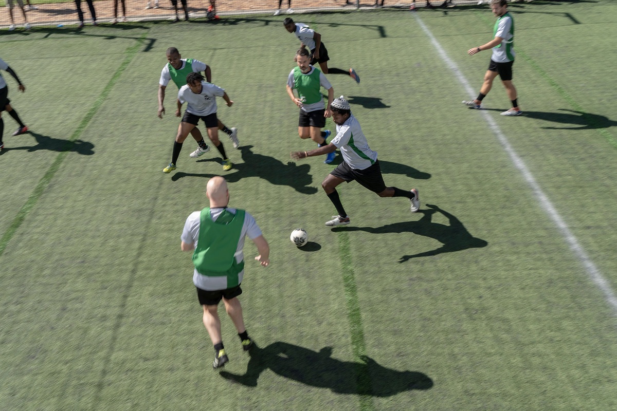 Match day photograph from the 2022 rendition of Exhibition Match that shows players participating in a soccer match.
