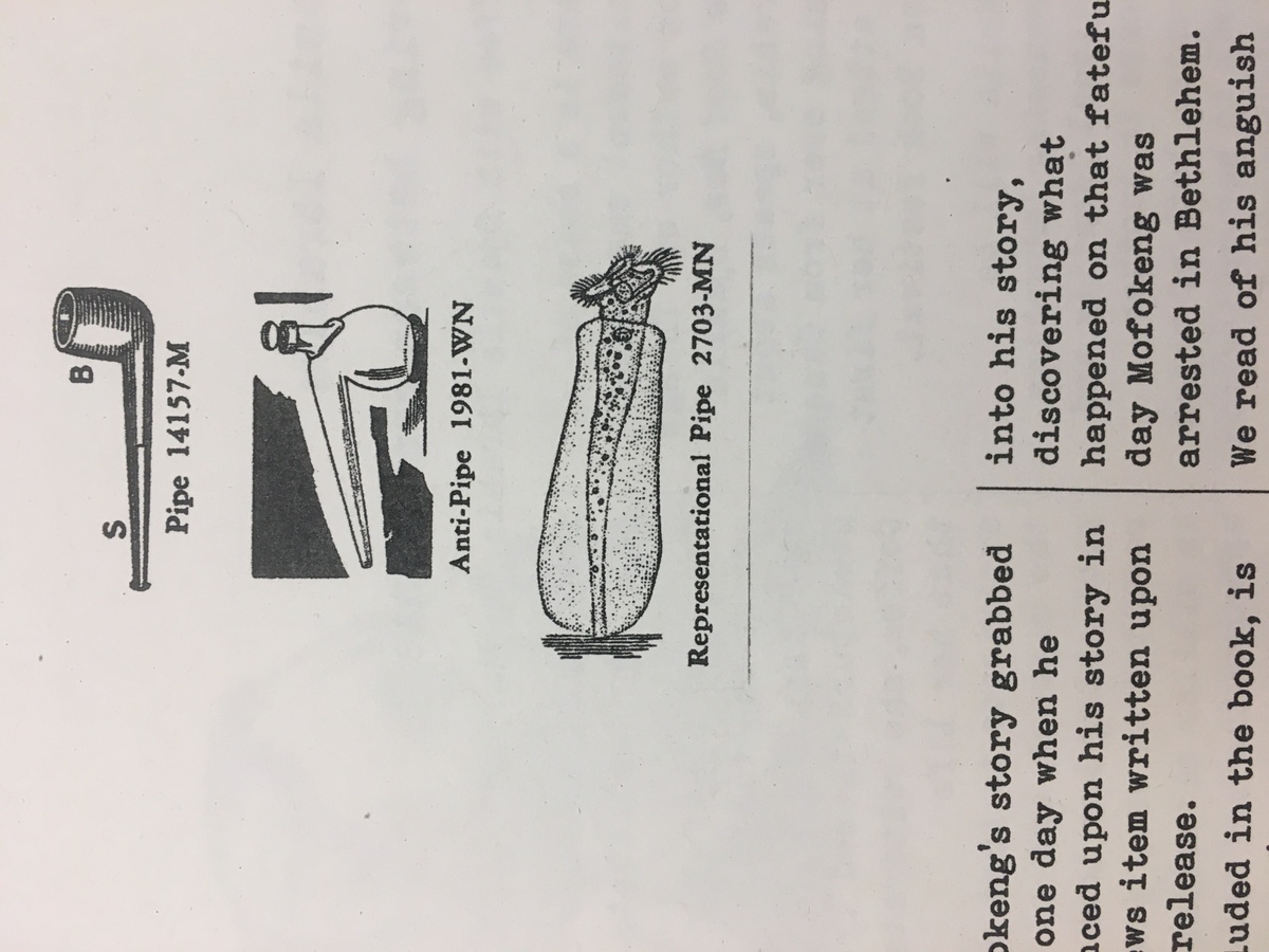 Photograph of the ‘OBZine’ publication from the 2019 rendition of the Open Book Literary Festival, with contributions from various student writers. A closeup view of a page shows illustrations of a pipe, an “anti-pipe” and a “Representational Pipe.”
