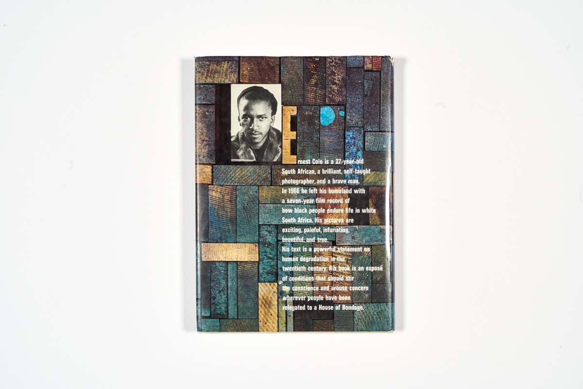 A topdown photograph of the back cover of Ernest Cole's photo-book 'House of Bondage' on a white background.
