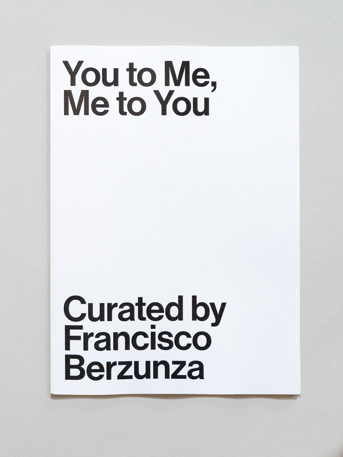 Photograph of the wayfinder publication for You to Me, Me to You curated by Francisco Berzunza in A4 Arts Foundation's Gallery.
