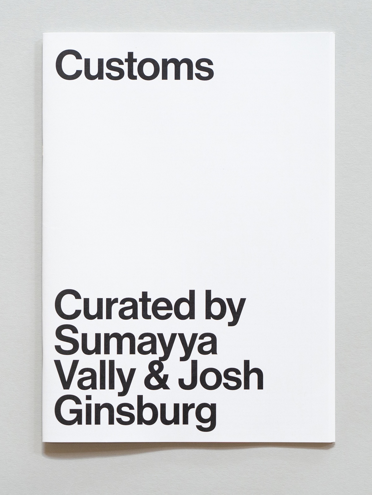 Photograph of the wayfinder publication for Customs, curated by Sumayya Vally and Josh Ginsburg in A4 Arts Foundation's Gallery.
