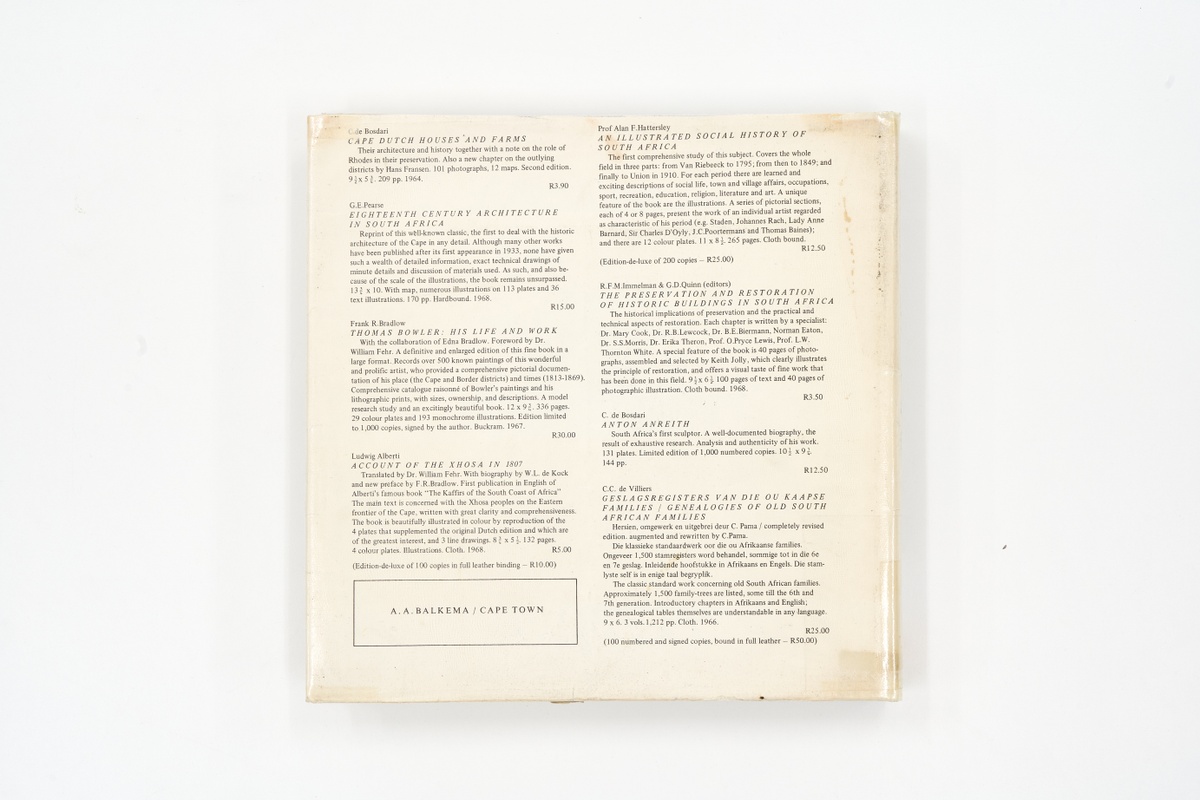 A topdown photograph of the back cover of Arthur Elliott's photo-book 'Architectural Beauty of the Old Cape as Seen by Arthur Elliot' on white background.
