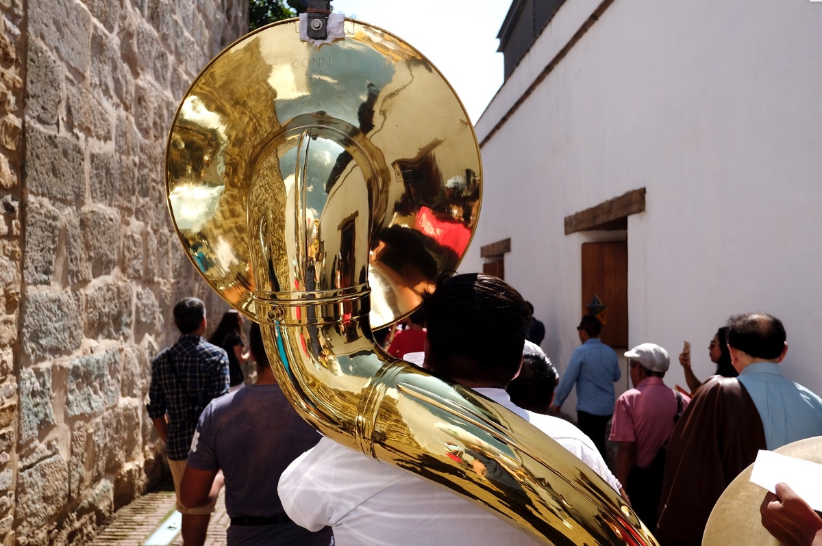 Ephemera from the series of offsite exhibitions ‘Crossing Night / Hacer Noche’ in Oaxaca, Mexico. A photograph depicts a man with a trombone walking in the opening parade for the project.
