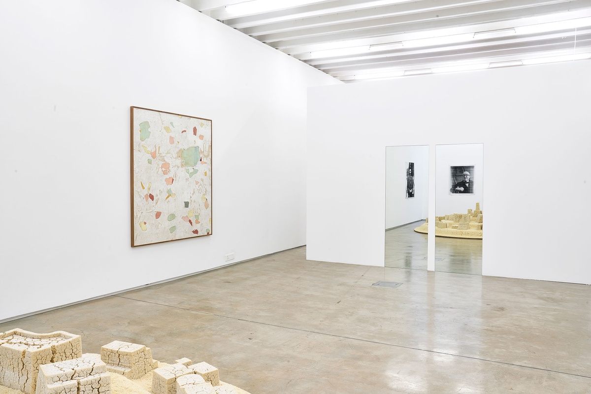 Installation photograph from the The Future Is Behind Us exhibition in A4’s Gallery. On the left, Asemahle Ntlonti’s framed mixed-media work ‘Emaphandleni’ hangs on the wall. On the right, Félix González-Torres’ mirror installation '“Untitled” (Orpheus, Twice)' is mounted on the wall.
