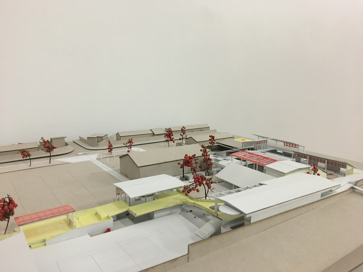 Photograph of an artwork from the Masters of Architecture Graduate Exhibition on A4’s top floor that consists of a cardboard model of a building.
