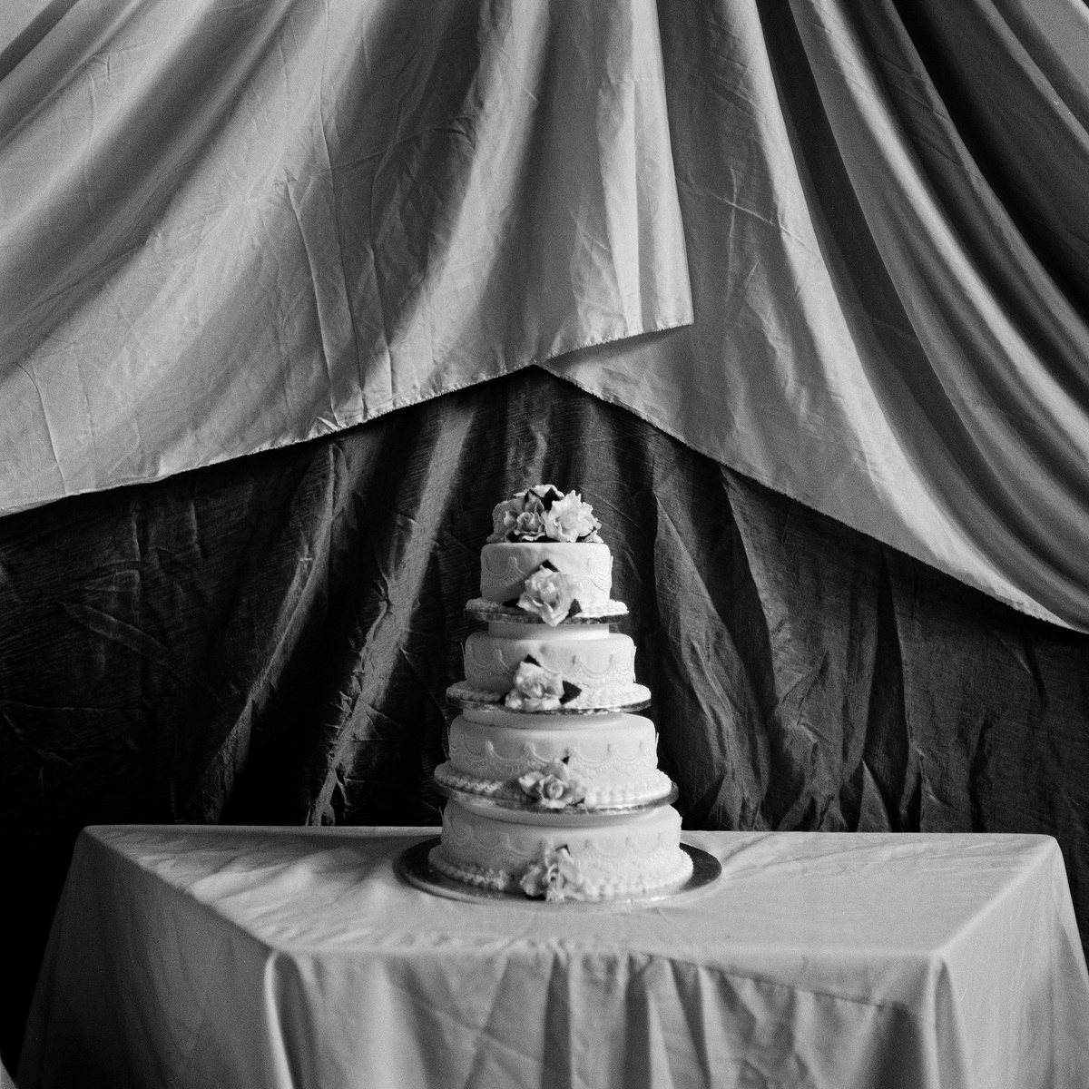 Sabelo Mlangeni’s ‘Ikhekhe Lomshado’, a black and white photograph that depicts a layered wedding cake.
