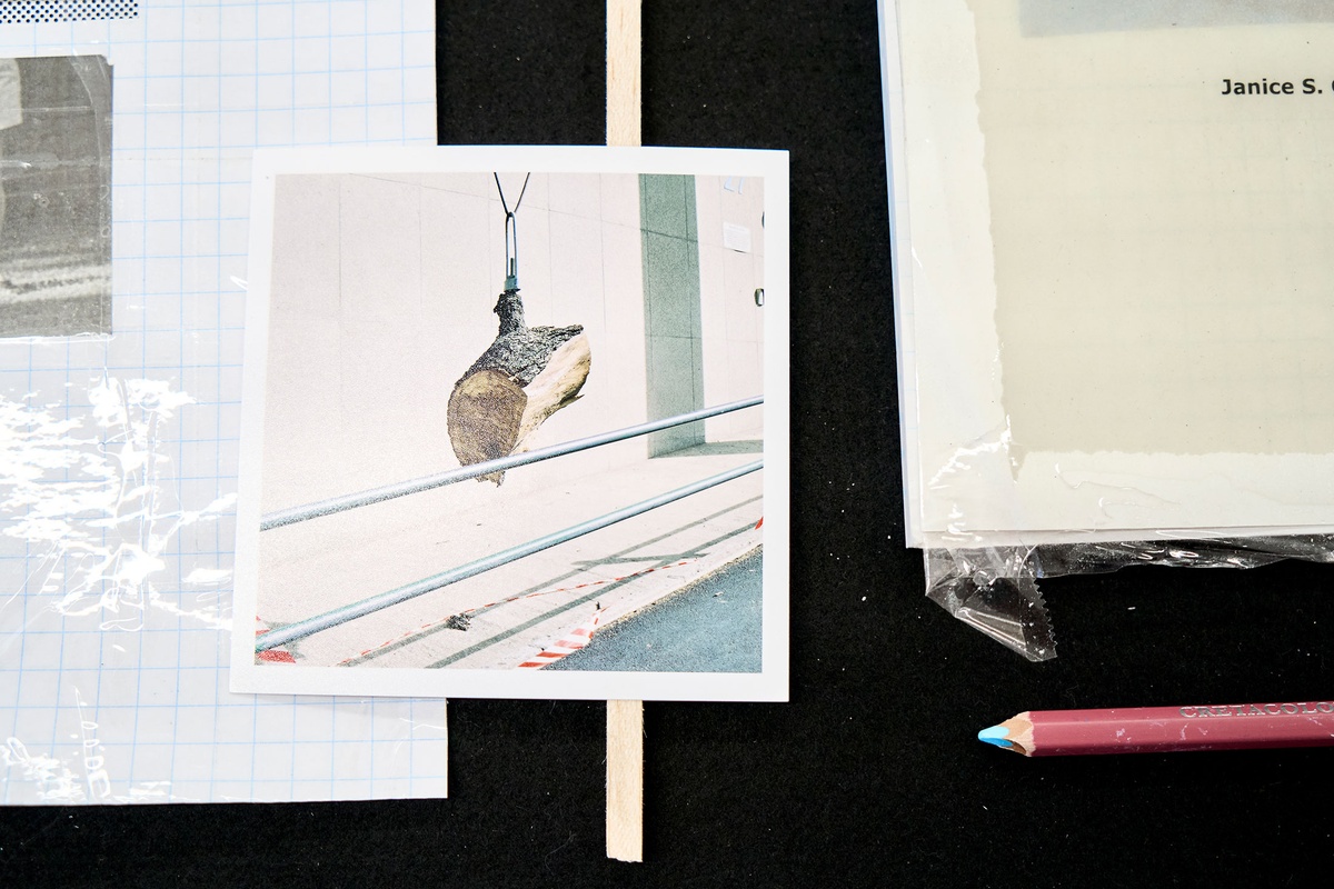 Installation photograph of Michael Tymbios’ studio during his residency in A4 Arts Foundation. A closeup view of a freestanding display case that holds photographs and ephemera.
