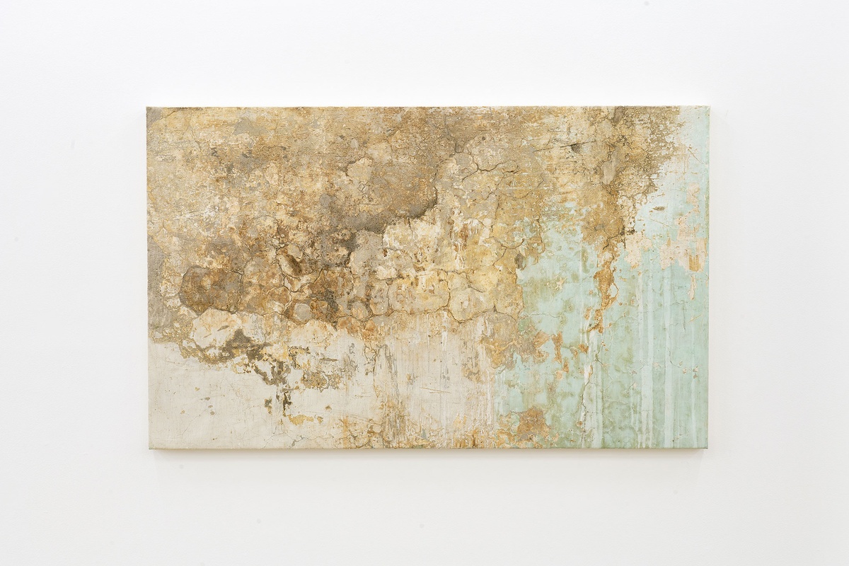 Installation photograph from The Future is Behind Us exhibition in A4’s Gallery. In the middle, Gian Maria Tosatti’s plaster on canvas work ‘5\_I fondamenti della luce - archeologia (intonaco 7)’ is mounted on a white wall.
