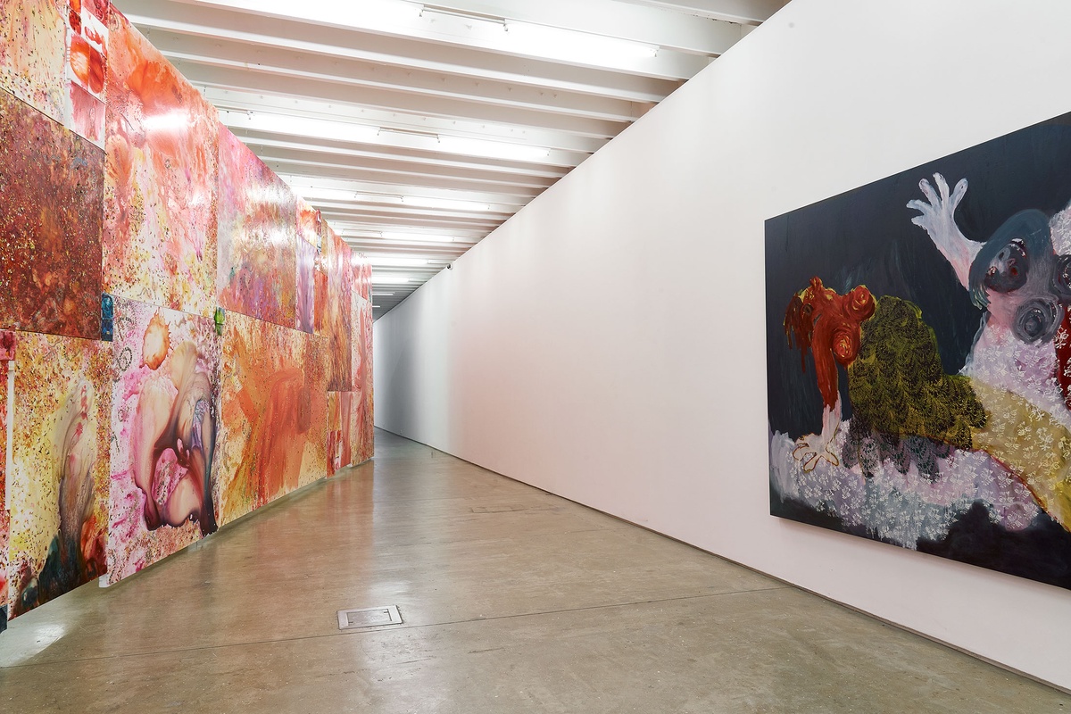 Installation photograph from the 'A Little After This' exhibition in A4 Arts Foundation's gallery. On the left, an installation of Penny Siopis' glue, ink and oil 'Maitland' paintings suspended from the ceiling. On the right, Portia Zvavahera's oil-based printing ink and oil bar on canvas work 'Embraced and Protected in You' mounted on a white gallery wall.
