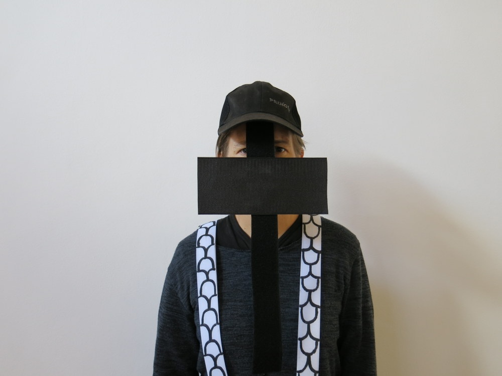 Process photograph from the ‘Wearables’ workshop with Unathi Mkonto on A4’s top floor that shows an attendee with a velcro wearable partially covering their face.
