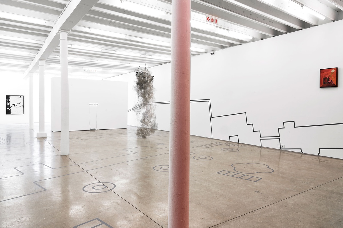 Installation photograph from the Customs exhibition in A4’s Gallery. On the left, Dor Guez’s photographic print ‘Samira’ is mounted on a white gallery wall. In the middle, Igshaan Adams’ mixed media sculpture ’65 Bloem Street’ is suspended from the ceiling. On the right, Peter Clarke’s acrylic painting ‘Anxiety’ is mounted on a white gallery wall.
