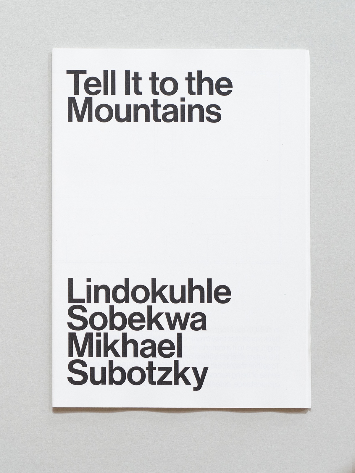 Photograph of the wayfinder publication for Tell it to the Mountains exhibition by Lindokuhle Sobekwa and Mikhael Subotzky in A4 Arts Foundation's Gallery.
