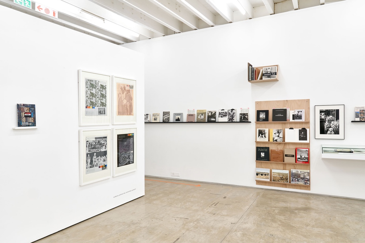 Installation photograph from the Photo Book! Photo-Book! Photobook! exhibition in A4’s Gallery. On the left, four screen prints from Gavin Jantjes’ ‘Colour These Blacks White (A South African Colouring Book)’ series is mounted on the wall in an area dedicated to photobooks from the years 1945 to 1967.
