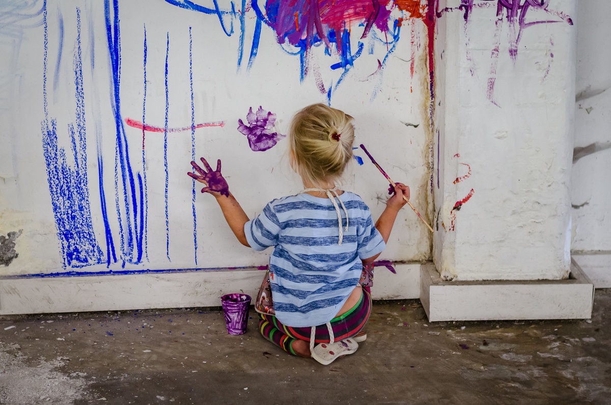 Event photograph from ‘Kids Art Collective’ on A4’s ground floor shows a child painting on a white wall.
