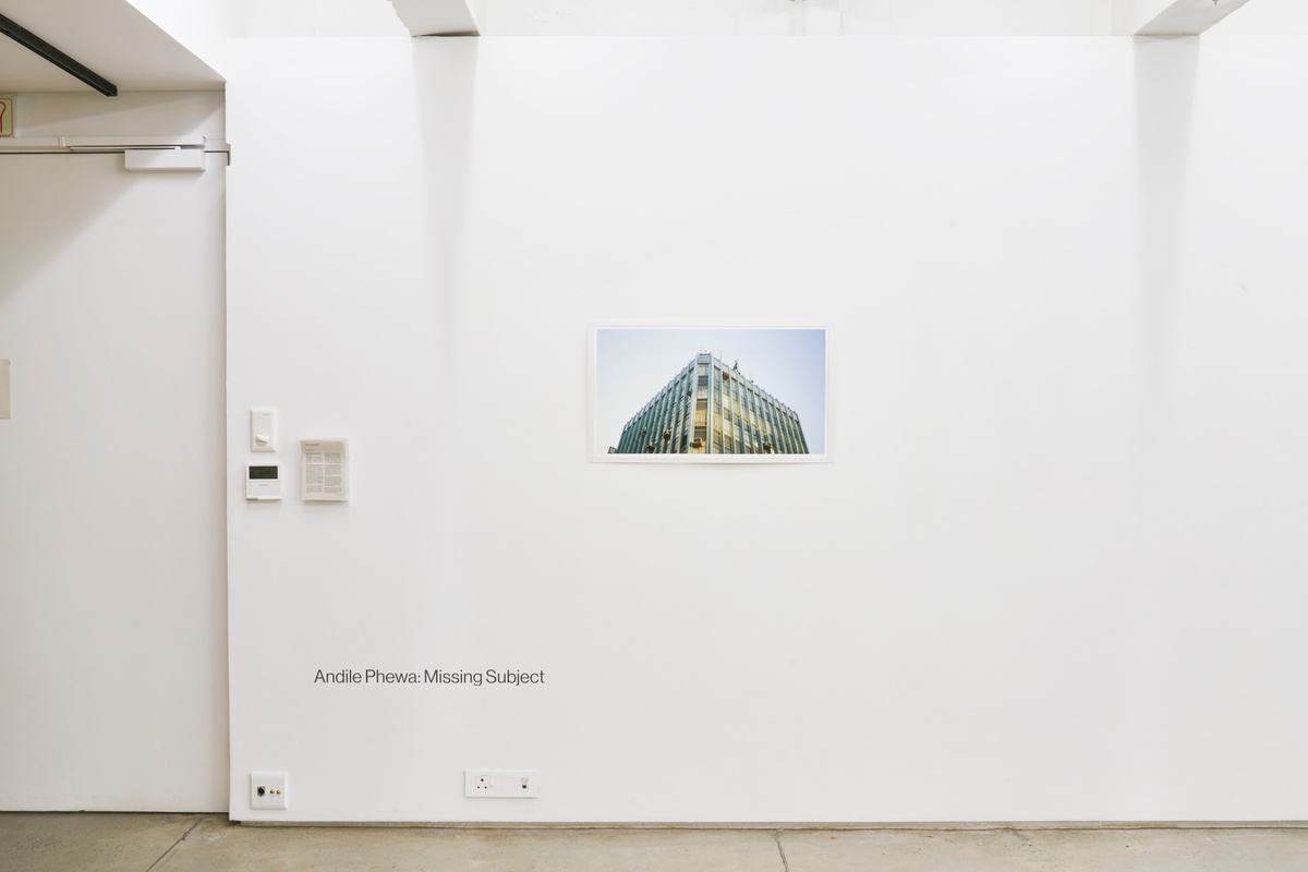 Installation photograph from the ‘Missing Subject’ exhibition in A4’s Library. In the middle, Andile Phewa’s photograph ‘Bluesky Port’ is mounted on the wall.
