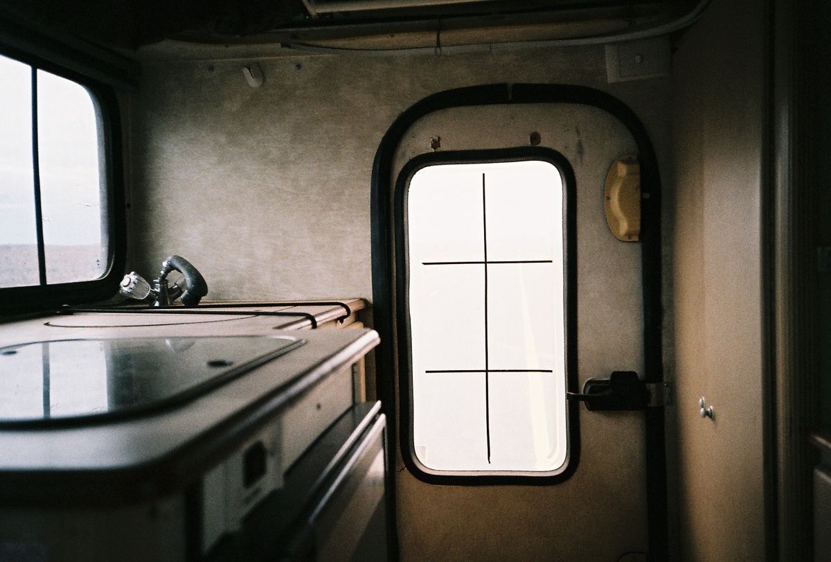 Process photograph from the making of Daniel Zimbler's documentary on David Goldblatt that shows a small indoor kitchen area in room with metal walls.
