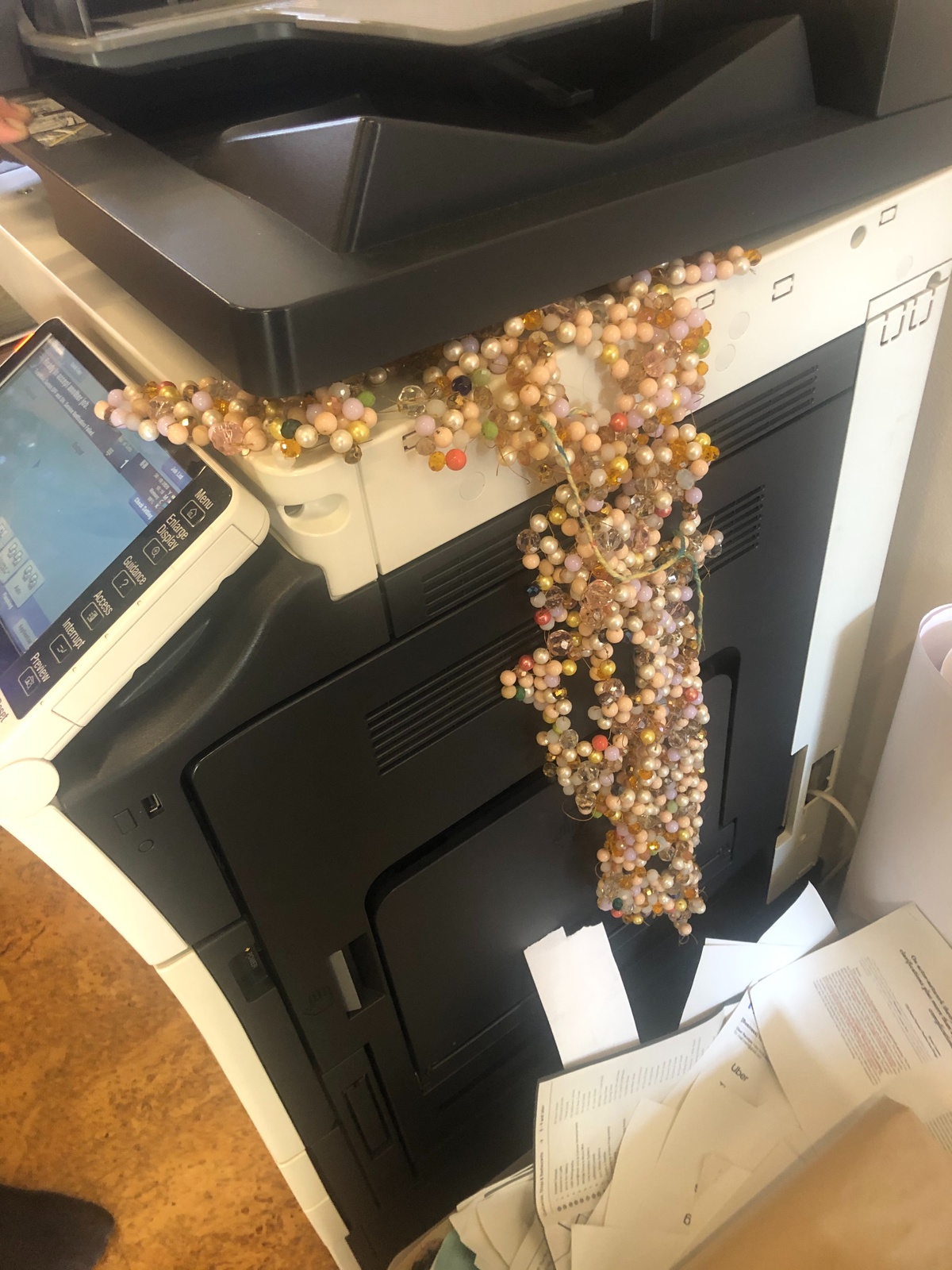 Process photograph from ‘Open Production’, Igshaan Adams’ hybrid studio/exhibition in A4’s Gallery, shows a sample of Adams’ beadwork protruding from the flatbed of A4’s photocopier.
