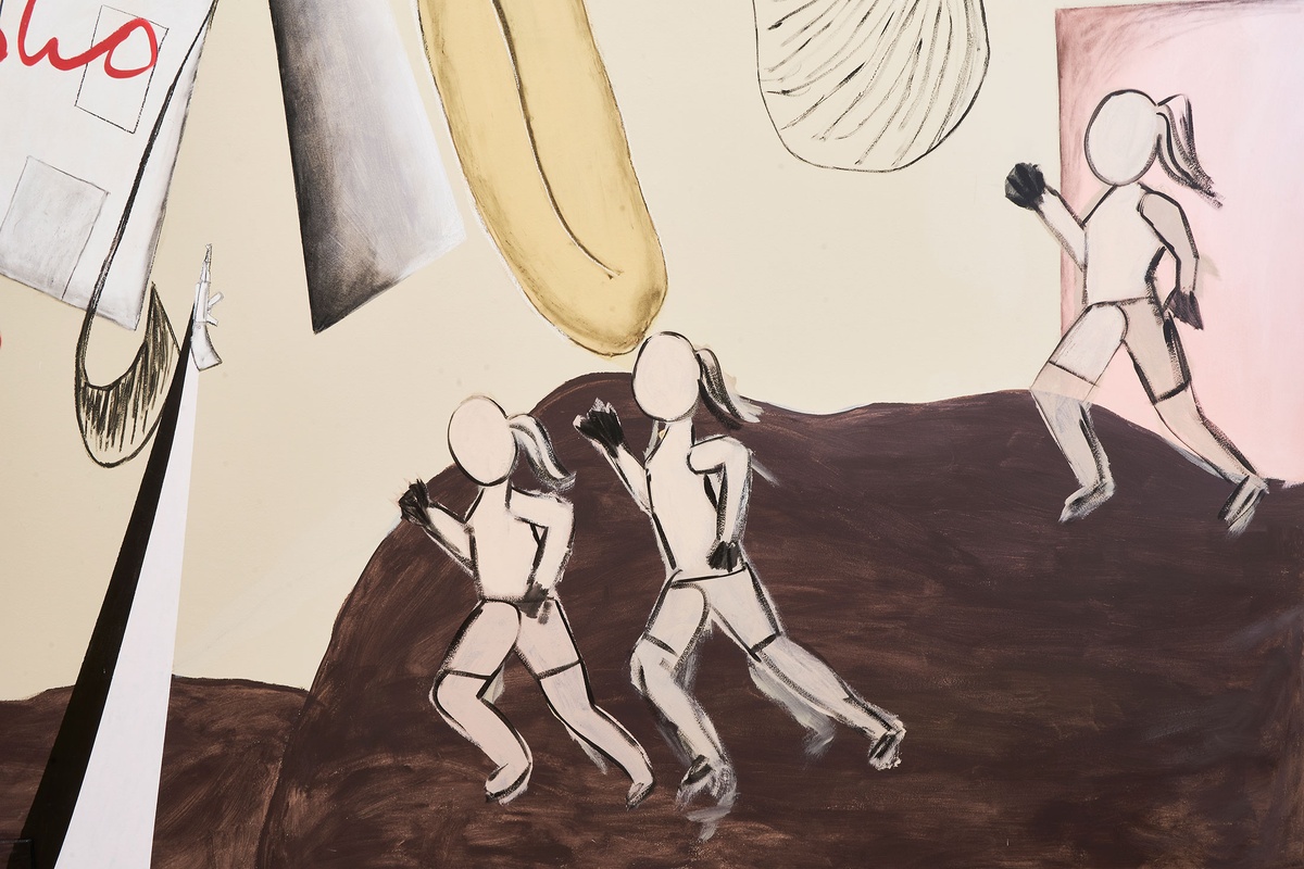 A photograph of a detail from ‘The Prodigal Daughter,’ a wall mural by Hannah Noor Mohamed, that depicts three femme figures running on a brown coloured mass.
