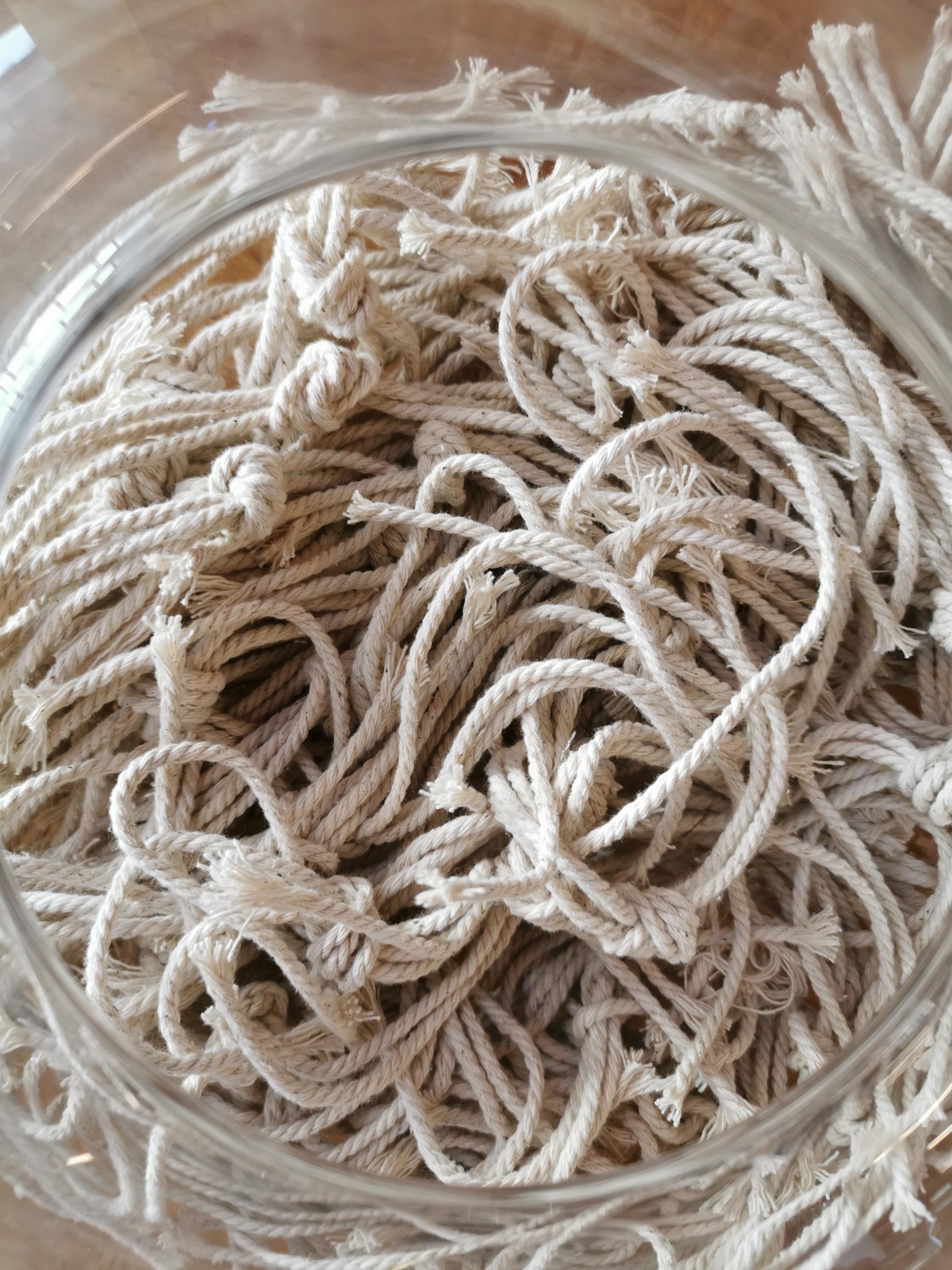 Event photograph from ‘Knots’, a conversation between Igshaan Adams and Josh Ginsburg, marking the close of ‘Open Production’, Adams’ hybrid studio/exhibition in A4’s Gallery. In the middle, a closeup view of a glass vase that holds bunches of white thread.
