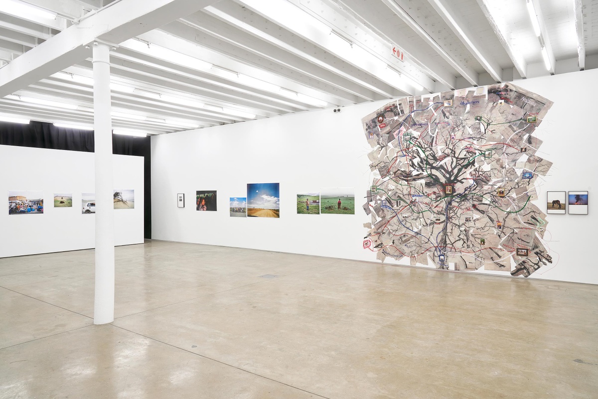 Installation photograph from the ‘Tell it to the Mountains’ exhibition in A4’s Gallery. On the left, Lindokuhle Sobekwa’s photographs line the gallery walls. On the right, Sobekwa’s paper and photo collage ‘Mthimkhulu II’ is pasted onto the wall.
