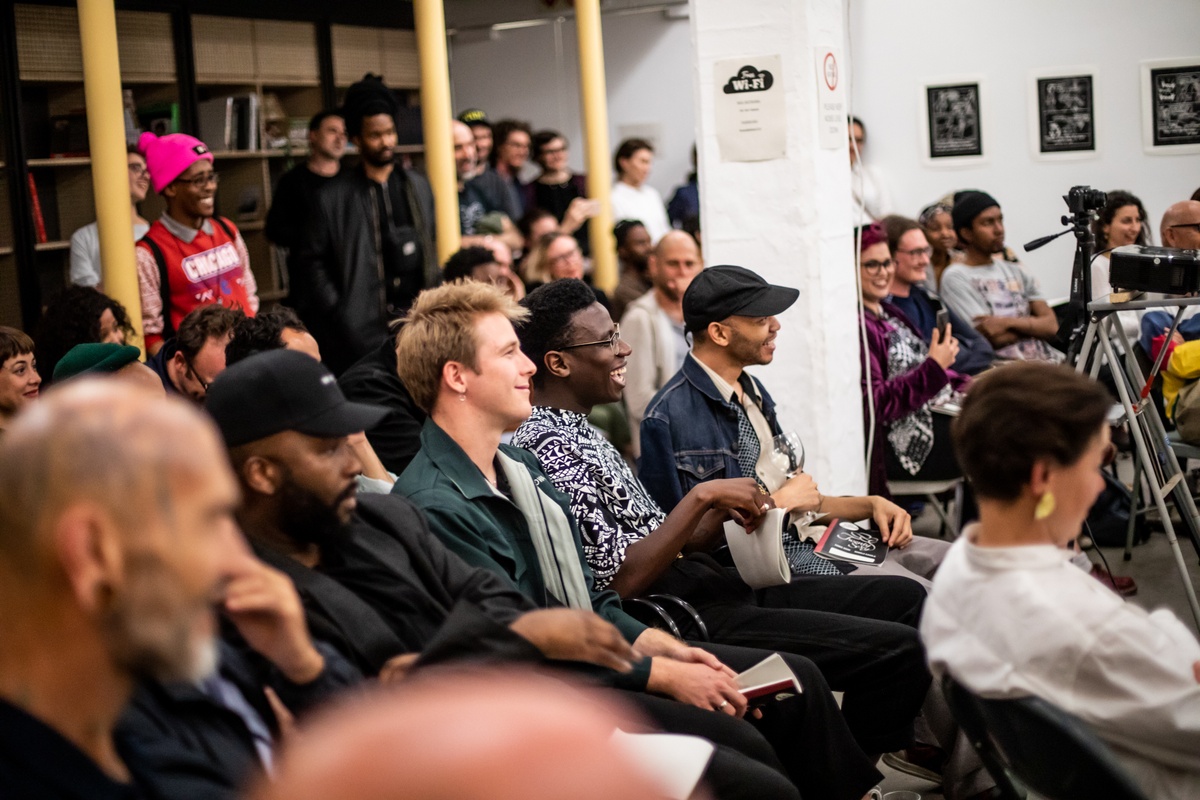 Event photograph from the “Bonolo Kavula presents ‘Art Times’” event in A4’s Library shows attendees seated in rows.
